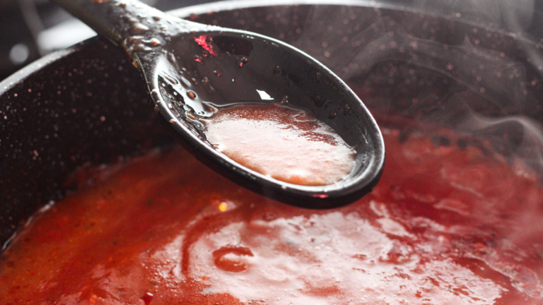 A pot of tomato-based sauce cooking